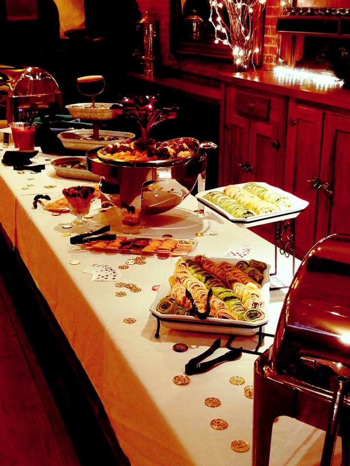 Spread of appetizers including pinwheels, meat and cheese tray, and crackers